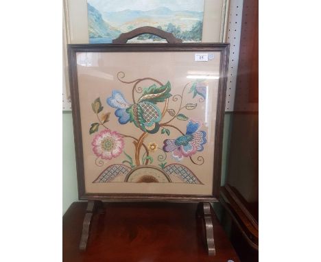 of square form the oak frame enclosing a floral tapestry panel, resting on raised legs 