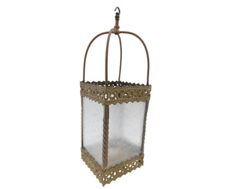 An early 20thC gilt lantern, the arched crest above a pierced floral frame, 64cm high, 21cm x 21cm base. WARNING! This lot co