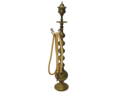 An Eastern engraved and pierced brass hookah pipe, 120cm high. 