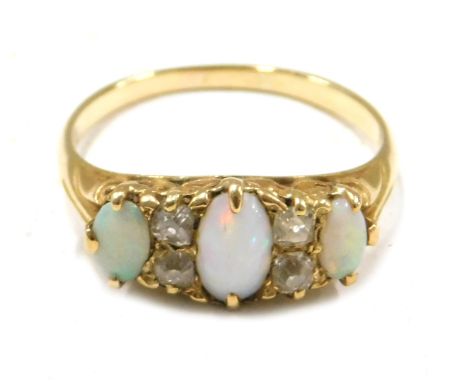 An 18ct gold opal and diamond dress ring, set with three oval opals and four old cut diamonds, ring size P, 3.9g all in. 