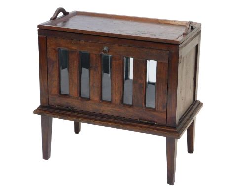 An Old Java hardwood tea table or drinks cabinet, with removable two handled tray, above a part glazed front and back, one si