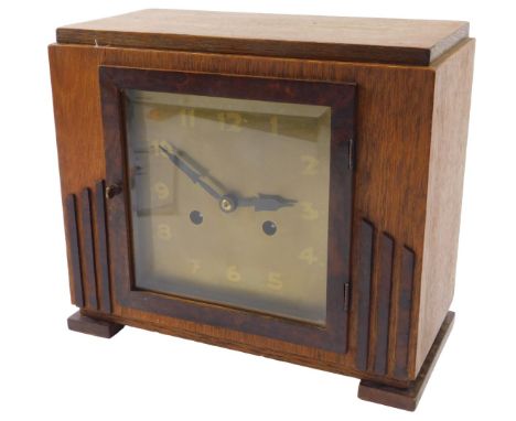 An Art Deco style teak and burr wood mantel clock, 28cm wide.  