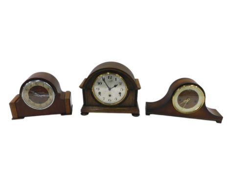 Three mantel clocks, comprising a 20thC oak cased mantel clock, with silvered numeric dial, dome top, on bun feet, 23cm high,