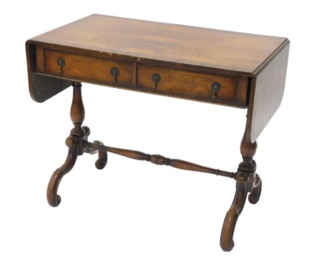 A walnut sofa table, in Regency style, the quarter veneered top with a top banded border above two frieze drawers, on turned 