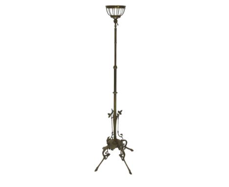 A late 19th/early 20thC brass floor lamp, with fitting for an oil lamp, the base with four pierced and leaf cast legs and oge