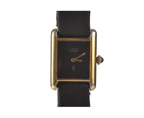 A Must de Cartier Tank lady’s vermeil manual wind wristwatch, the rectangular black signed dial with gold baton hands, caboch