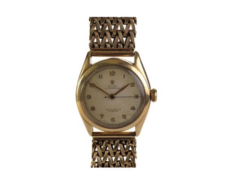 A 1950s Rolex Oyster Perpetual ‘bubble back’ gentleman’s 9ct gold wristwatch, ref. 6084 no.837904, the signed cream dial with