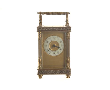 An English brass carriage clock, with decorative borders, and swing handle, 11cm high 