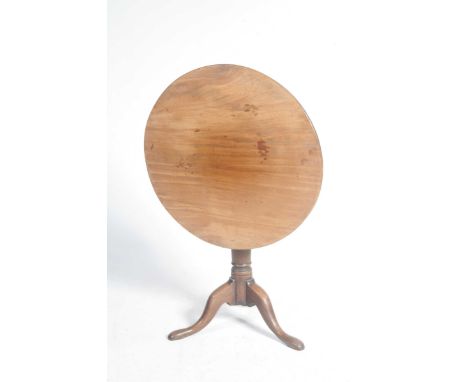 A Georgian mahogany tripod tableThe circular top supported on a ring turned shaft, three downswept supports and pad feet, 75x