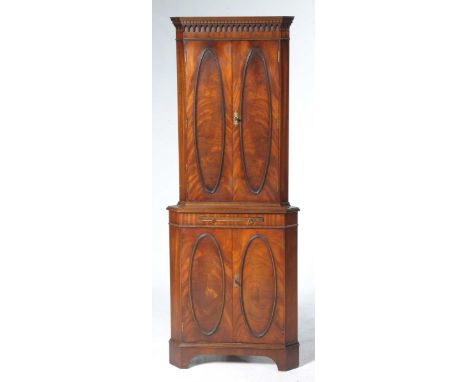 A good quality reproduction free standing cocktail cabinetWith a dentil cornice above two beaded doors enclosing two shaped s