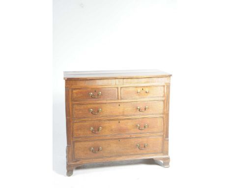 A George IV oak and mahogany crossbanded chest of drawersWith two inlaid secret frieze drawers above an arrangement of two sh