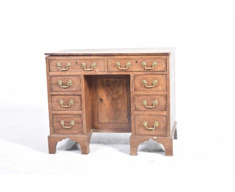 A good quality George III mahogany deskWith a rectangular top above two frieze drawers over a central inverted cupboard doors