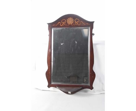 An Edwardian inlaid mahogany wall mirrorThe Serpentine top inlaid with a tapered ribbon and shell motif, the scalloped sides 