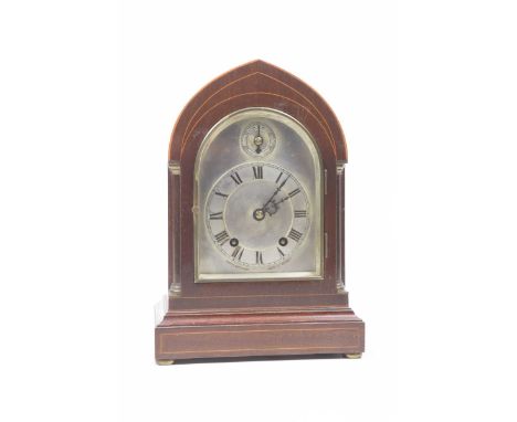 An Edwardian inlaid mahogany lancet topped bracket clockThe silvered dial having Roman numerals, retailed by Joseph Beringer 