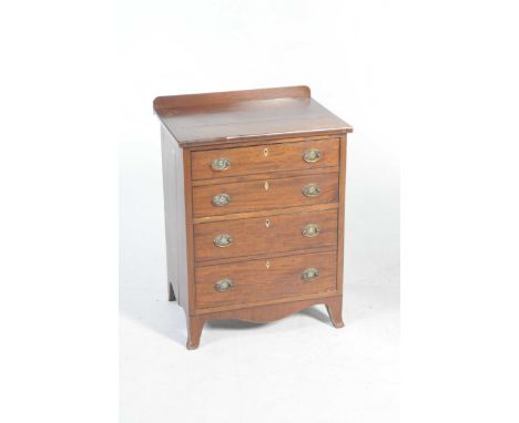 A Georgian mahogany chest of small proportionsThe rectangular top above two faux double drawers each applied with brass swing