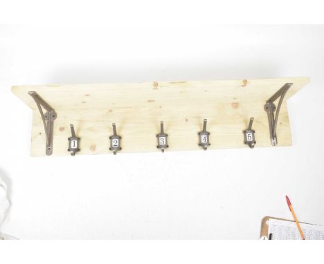 A vintage style coat rack and shelfThe plank top and side with five individual gun metal style hooks with brackets and upper 