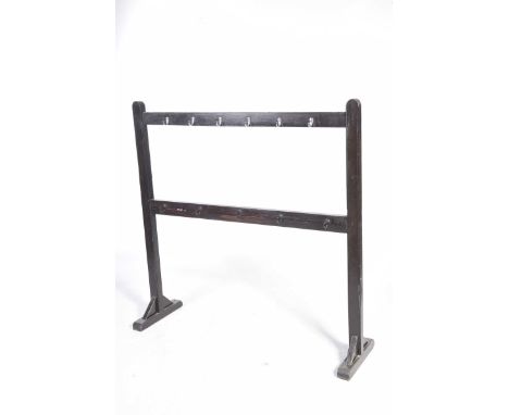 A vintage painted pine freestanding nursery coat rackConstructed with two parrallel rails each applied with coat hooks and su