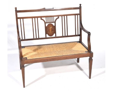 An Edwardian inlaid mahogany two seater chairThe rail back centered with a panel inlaid with a classical female figure above 