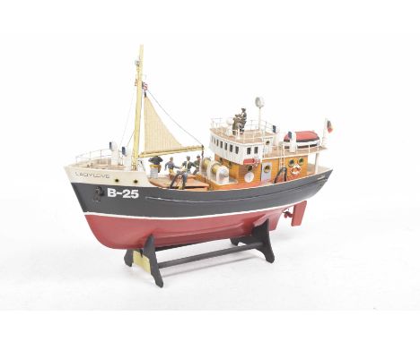 A small kit built trawlerWith red and black hull, plank effect decking and plank and white superstructure with single propell