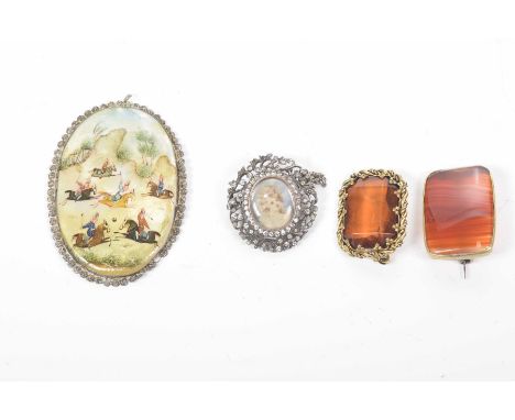 A banded agate and gilt metal broochTogether with, a white paste portrait brooch, an orange paste brooch and a middle Eastern