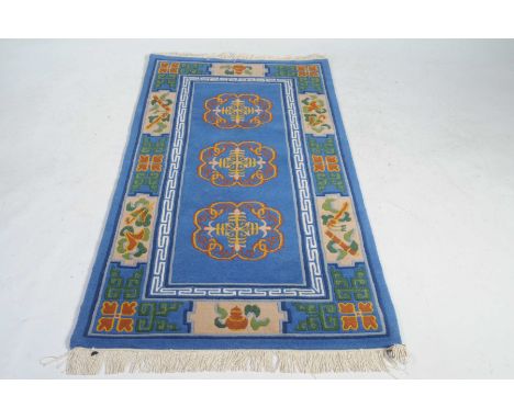 A Chinese style blue ground runner
The vibrant wool carpet detailed with traditional scroll and buddhistic motifs with centra