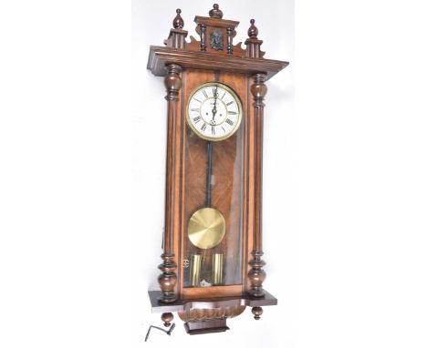 A Late Victorian Vienna wall clockThe mahogany case with turned columns flanking a glazed door with architectural pediment ma