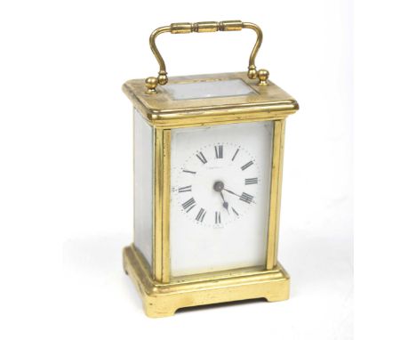 A French 19th Century four-glass brass carriage clockThe corniche case adorned with reeded loop handle enclosing the white en