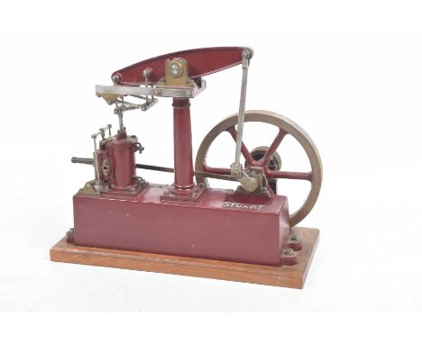 A good quality live steam stationary steam beam engine Single piston, with drive wheel, 'Stuart' in maroon on wooden base, le