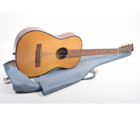 A Vintage acoustic guitar Of typical form, the six string instrument, unmarked, sold with blue leatherette case, 95cm long.