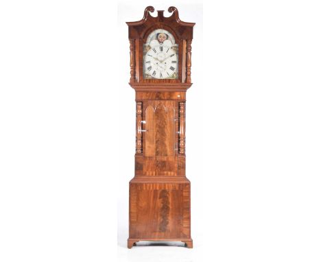 An early 19th Century mahogany cased eight day longcase clockWith a twin swan neck pediment above ring turned columns flankin