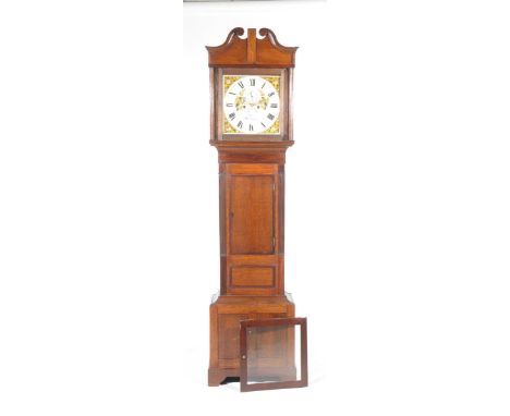 An early 19th Century oak and mahogany crossbanded eight day longcase clock by J Jones, Carnarvon The case with a twin swan n