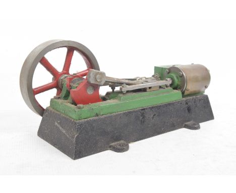 A good quality live steam stationary engine Green and black metal, with single drive wheel with red spokes, length 28cm, diam
