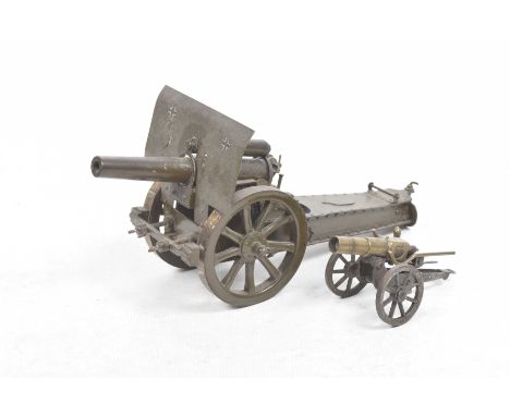 A large model of a German field gunLength 36cm and a small metal field gun, length 15cm.   CONDITION REPORT:  Lot 210No visib