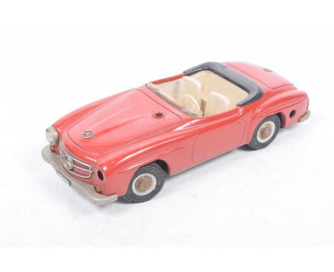 An unboxed Schuco no. 2095 Mercedes 190SL open topRed tinplate model with beige plastic interior, parts including detailed hu