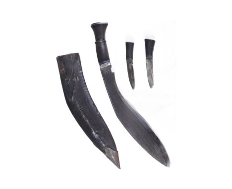 A vintage Nepalese / Gurkha Regiment Kukri knife dagger. The knife having a pommel with diamond shaped lozenge and a carved h