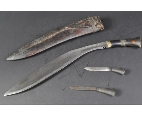 A vintage Nepalese / Gurkha Regiment Kukri knife dagger. The knife having a brass capped pommel and carved horn grip. The cur