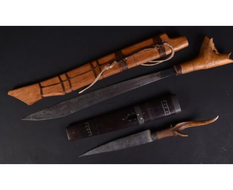 Two vintage South East Asian ethnic tribal daggers. One having an antler horn hilt and engraved tapering blade, the other a b