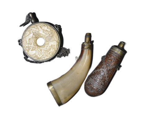 A collection of x3 assorted 19th Century musket powder flasks comprising; a circular shaped bone example carved with medieval