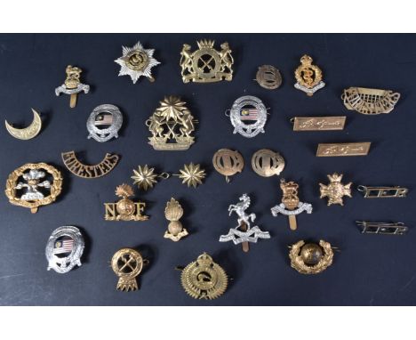A small collection of assorted First and Second World War (and other) military cap badges and collar titles to include; Briti