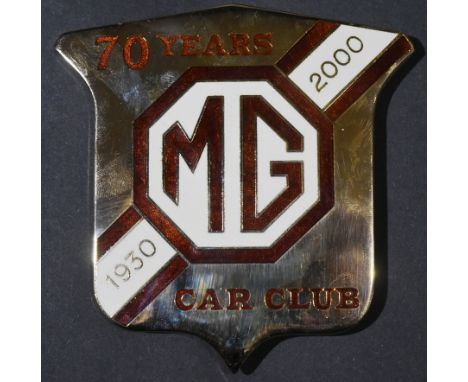 A Limited Edition MG Car Club 70th Anniversary car mascot badge. Chrome plated with brown and cream inlaid enamel logo. Appea