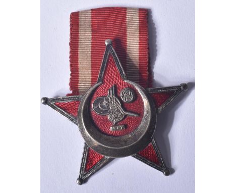 An original WWI First World War Turkish / Ottoman Empire Gallipoli Star medal. Star shaped badge with a red enamel ground and