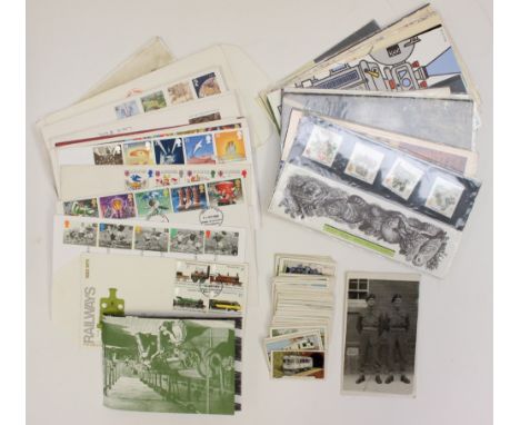 A box of First Day Covers and loose stamps 