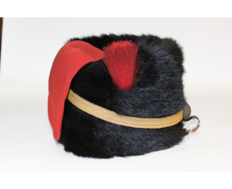 British Army Royal Artillery Busby. Black Seal skin body with red top and bag. With yellow strap and green boss. Red hair plu