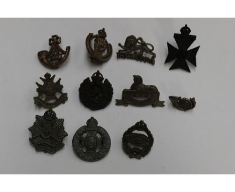 WW2 British Army war economy plastic cap badge collection: Eleven cap badges to include The Border Regt, Notts and Derby Regt