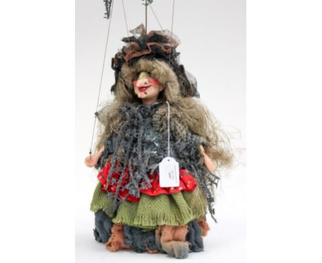 A carved wooden puppet, knitted costume 