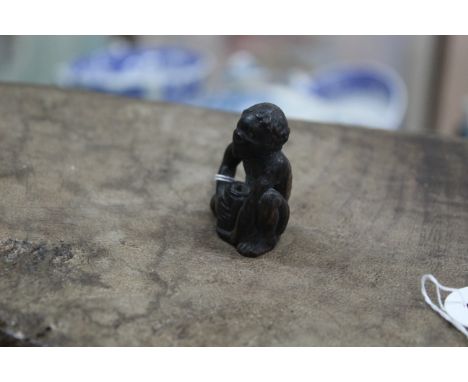 An antique carved wood netsuke on an emaciated man with pot, inset metal eyes, not signed, 1 1/2" high