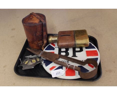 A cast iron 'B.P. Motor Spirit' sign, an AA car badge, iron sheep shears, three bottle leather encased flask set plus a brass