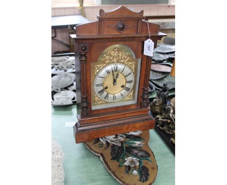 A mahogany cased striking mantel clock (lacking key), 16 3/4" high plus a Victorian beadwork low stool on six ceramic ball fe