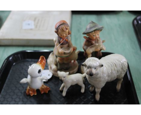 Two Goebel figurines, boy and girl, Beswick sheep, unmarked lamb and a Goebel duck