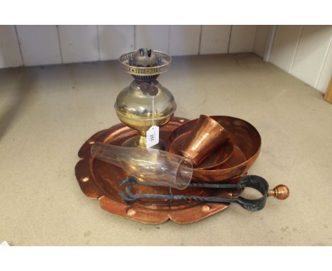 A round petal edged hammered copper tray, three copper bowls, fire tongs plus a brass oil lamp